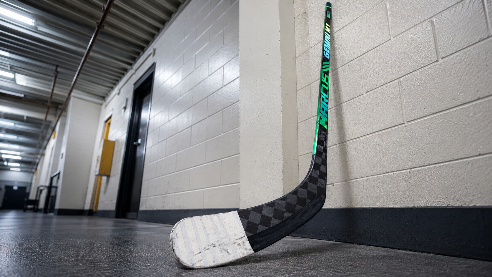 White-taped Marcus Hockey Gemini M1 blade in a rink hallway
