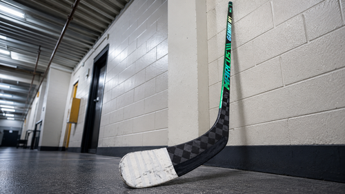 White-taped Marcus Hockey Gemini M1 blade in a rink hallway